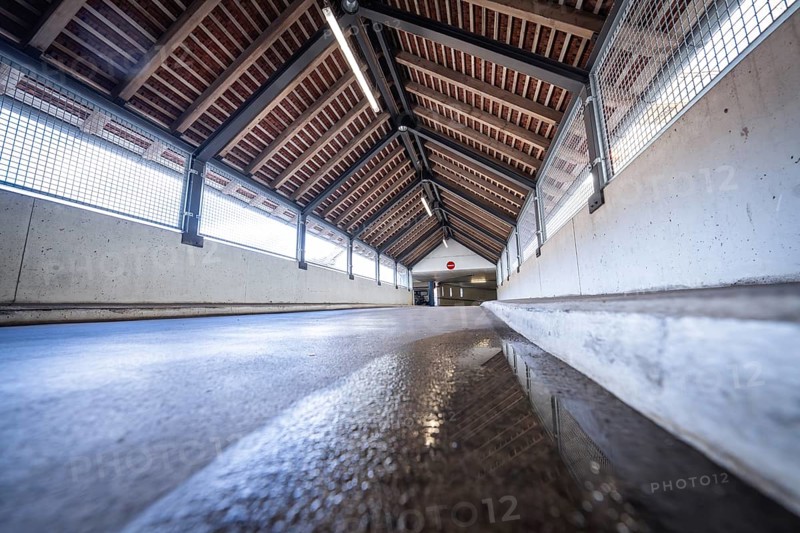Perspective corridor with wooden beam ceiling and incidence of light, reflected on the floor, car park ZOB of Stadtwerke Calw, Calw, district of Calw, Black Forest, Germany, Europe