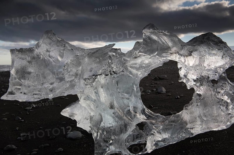 Little icebergs and crushed ice on the black beach at Joekulsarlon glacial lake