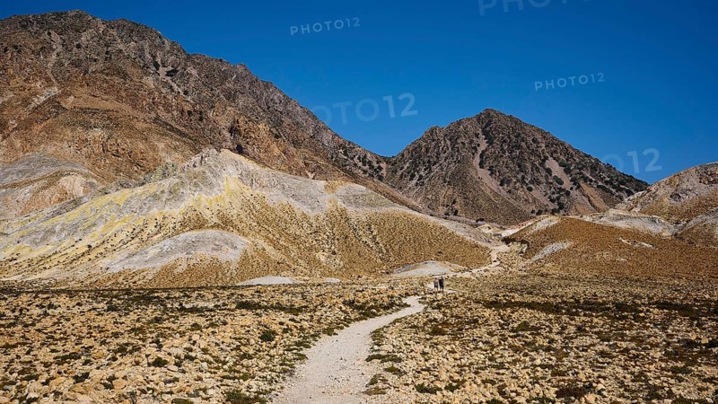 Hiking trail leading through a barren mountain landscape under a bright blue sky, volcanism, volcanic island, Polyvotis crater, Nisyros, Dodecanese, Greek Islands, Greece, Europe