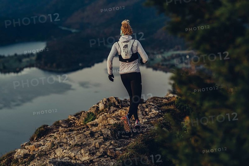 Trail running in autumn on the Jochberg on Lake Walchensee against the wonderful backdrop of the Alps, Bavaria, Germany, Europe