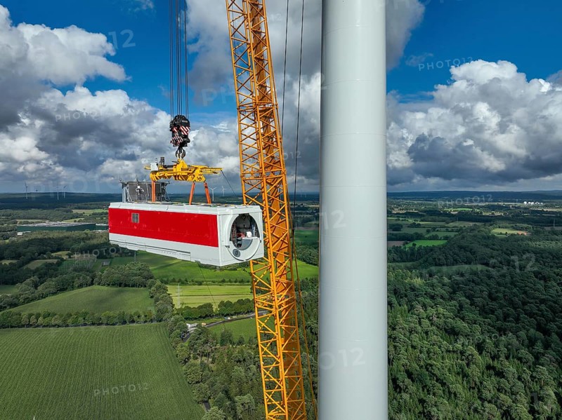 Dorsten, North Rhine-Westphalia, Germany, construction of a wind turbine, the first wind turbine of the Große Heide wind farm. A large mobile crane places the nacelle, the nacelle on the tower, Europe
