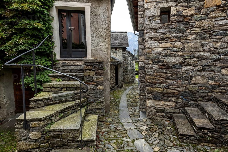 Typical Ticino stone houses in a narrow alley in the mountain village of Bordei, Centovalli, Canton Ticino, Switzerland, Europe