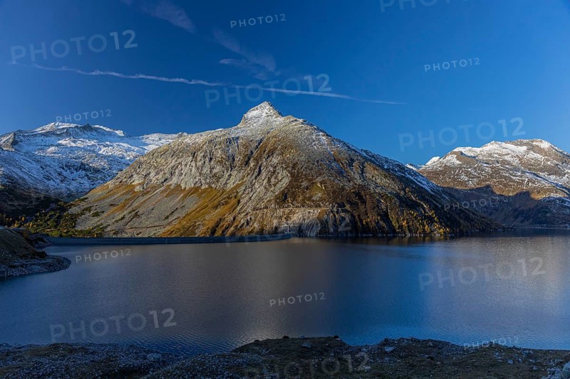 Kölnbrein reservoir and the Oberlecherspitzen mountain on a bright sunny morning. Seen from the Malta Hochalm road. Carithia, Austria, Europe