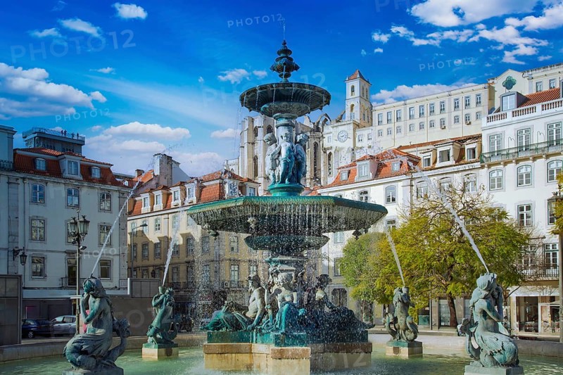 Lisbon, Rossio Square fountain and colorful historic buildings of historic city center