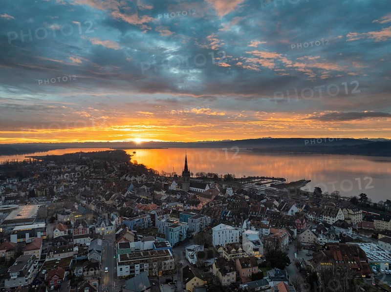 Aerial view of an atmospheric sunrise over the town of Radolfzell on Lake Constance with the cathedral tower, district of Constance, Baden-Württemberg, Germany, Europe