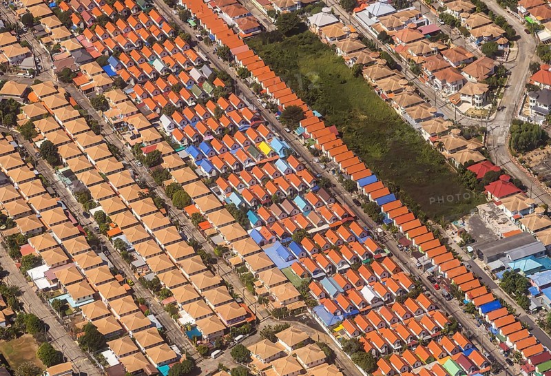 Retort city in the north-east of Bangkok. Standardised houses stand close together on the straight streets of a housing estate. Urban planning from the retort. Approaching Don Mueang Airport, Bangkok, Thailand, Asia