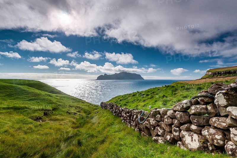 View of the island of Mykines, old stone wall, Gásadalur village, Vágar, Faroe Islands, Denmark, Europe