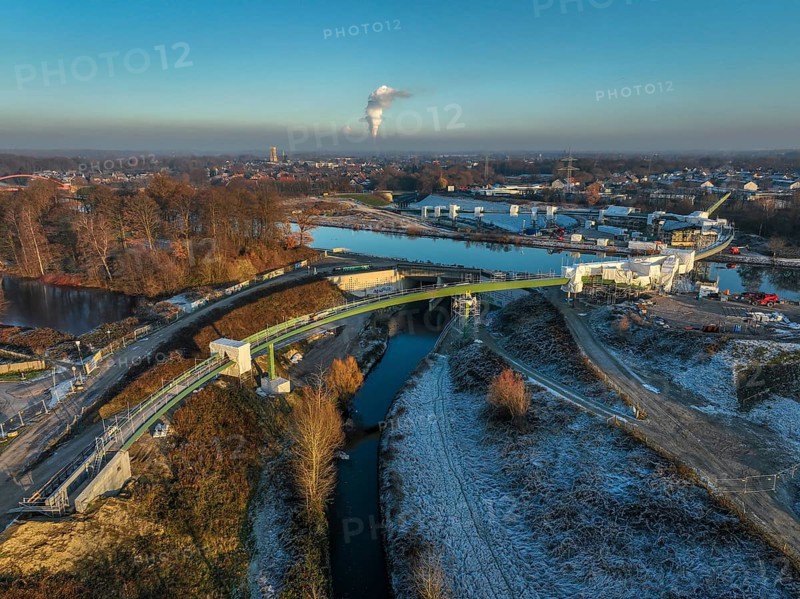 Castrop-Rauxel, North Rhine-Westphalia, Germany, new construction of a bridge -jump over the Emscher-, a pedestrian and cycle bridge over the Emscher and the Rhine-Herne Canal. EMSCHERLAND construction project, a 37-hectare water and nature adventure park at the water crossroads of the Rhine-Herne Canal and the renaturalised Emscher on the border between Recklinghausen and Castrop-Rauxel. EMSCHERLAND will also be a garden of the future for the International Garden Exhibition 2027. Before the renaturalisation, the Emscher river system was an open, above-ground wastewater channel, mixed water channel with surface water and wastewater, Europe