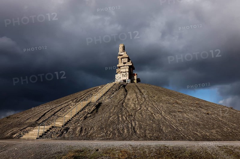Gelsenkirchen, North Rhine-Westphalia, Germany - Rheinelbe slagheap with artwork Himmelstreppe made of old concrete parts of the former Rheinelbe colliery in front of a dark sky, artist Herman Prigann