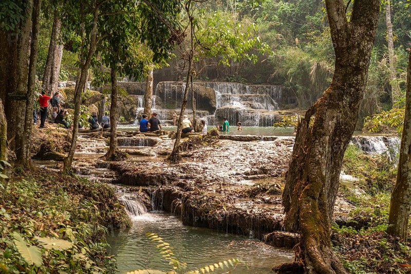 Tourists bathing in the Kuang Si waterfall near Luang Prabang, Laos, Asia