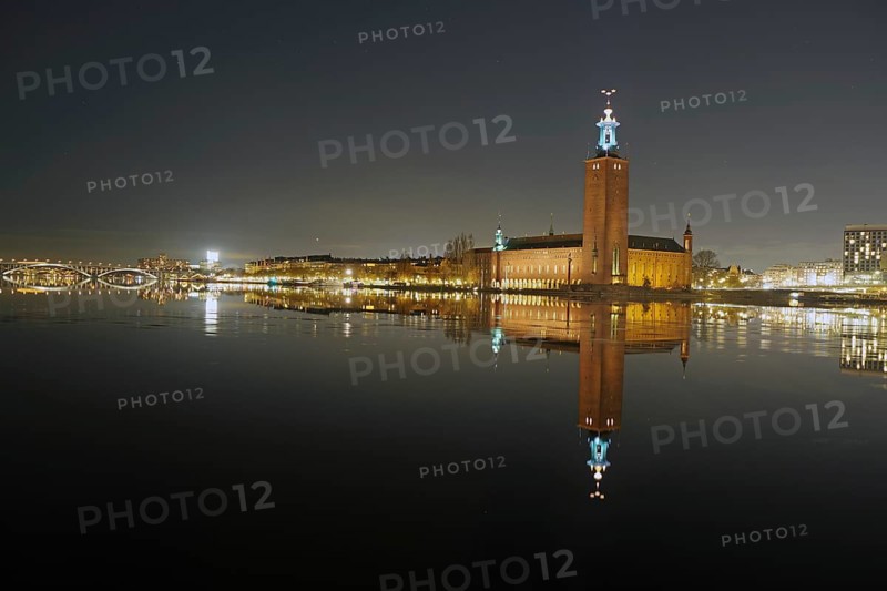 Illuminated building reflected in calm water at night, with a clear dark sky, capital city, city hall, Stadshus, Nobel Prize, Stockholm, Sweden, Europe