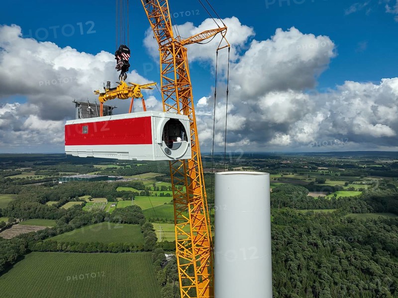 Dorsten, North Rhine-Westphalia, Germany, construction of a wind turbine, the first wind turbine of the Große Heide wind farm. A large mobile crane places the nacelle, the nacelle on the tower, Europe