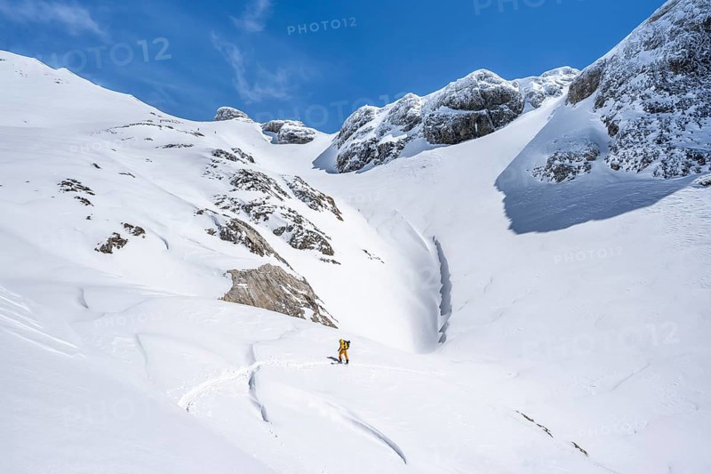 Lone ski tourer in mountain landscape with snow, ascent to Wildstrubelhütte, Bernese Alps, Switzerland, Europe