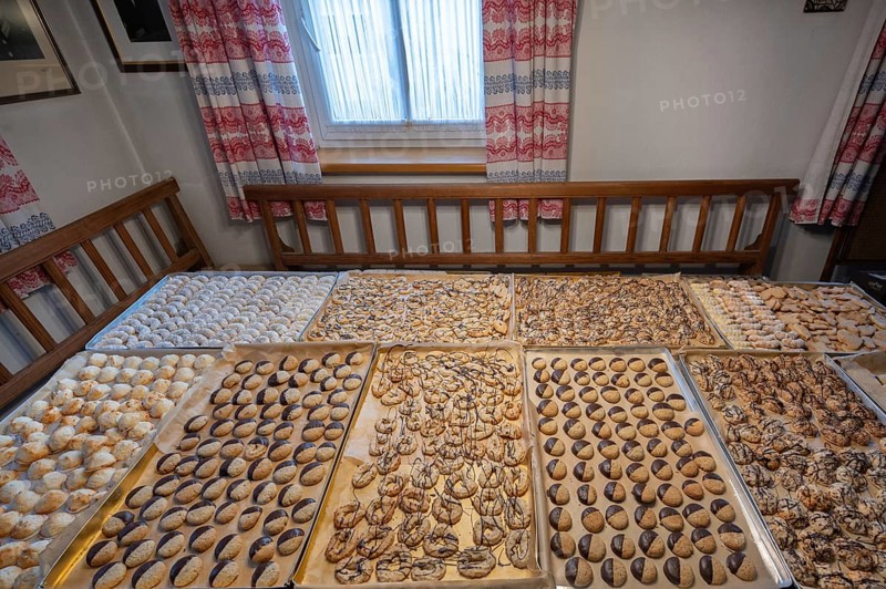 Ready-baked biscuits arranged on baking trays on the table, Bavaria, Germanybd
