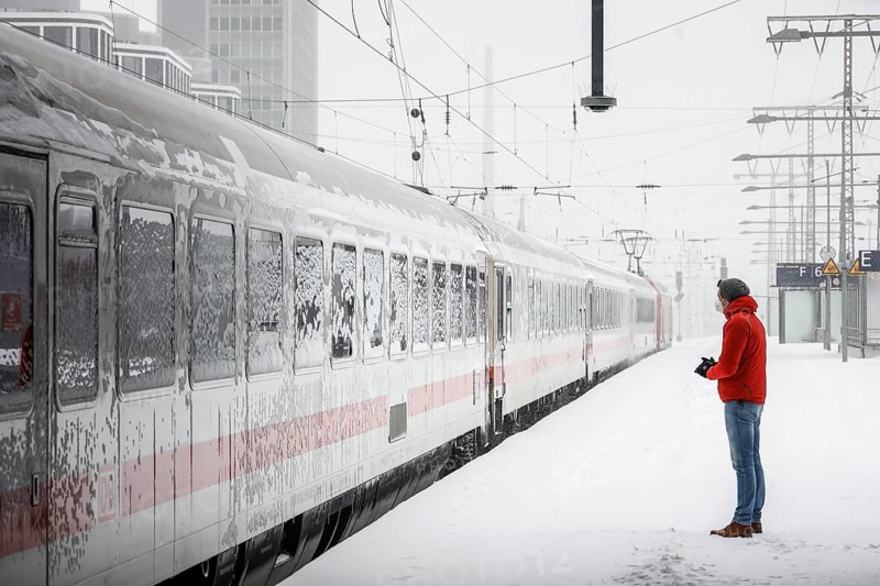 Essen, North Rhine-Westphalia, Germany - Onset of winter in the Ruhr area, Essen railway station, many trains are delayed or cancelled due to ice and snow, passenger waiting for train