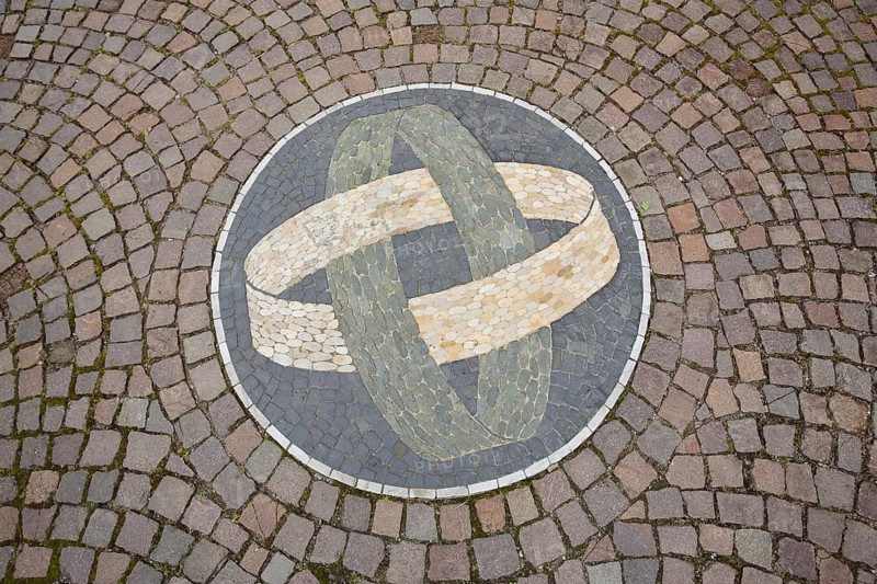 Two round rings with floor mosaic as a symbol of connectedness, paving stones, tyres, circles, into each other, together, belonging together, inside, with each other, curved, intertwined, round, connected, unity, inseparable, wedding rings, Gernsbach, Black Forest, Northern Black Forest, Baden-Württemberg, Germany, Europe