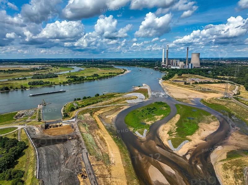Dinslaken, Voerde, North Rhine-Westphalia, Germany, renaturalisation of the Emscher. On the right, new mouth of the Emscher into the Rhine. On the left, the old former estuary is being filled in. In the background, the decommissioned STEAG Voerde coal-fired power station. The mouth of the Emscher into the Rhine was moved from Dinslaken to Voerde, just under 500 metres to the north. Fish can now swim barrier-free up the new Emscher from the Rhine through a newly created floodplain area. Following the construction of a parallel sewer, the Emscher has been completely free of sewage since January 2022. The river was previously an open, above-ground combined sewer with rainwater and wastewater, Europe