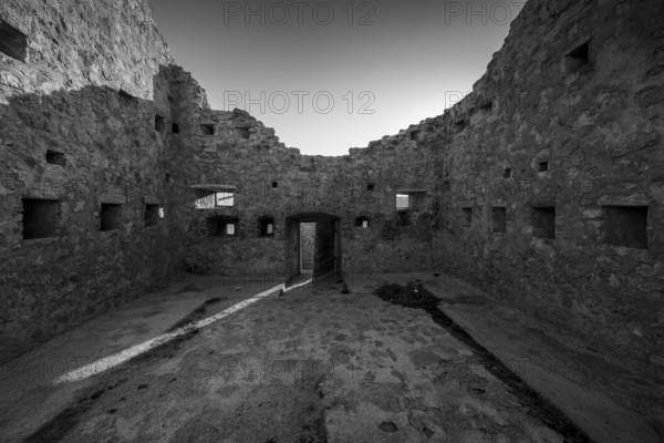 Abandoned ruin in black and white with an old entrance and crumbling walls, Pag, Croatia, Europe