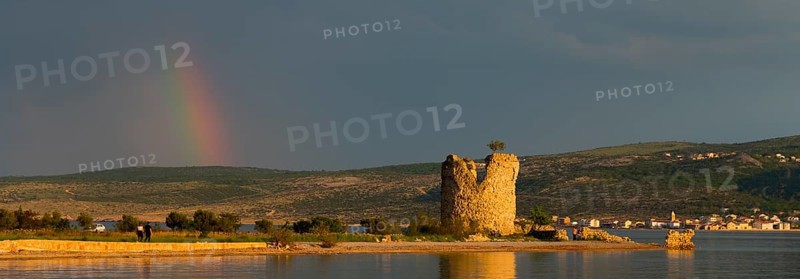 Old tower ruins on the coast with a rainbow in the distance at dusk, Vecka kula, Vecka Kula, Starigrad, Starigrad-Paklenica, Zadar, Croatia, Europe