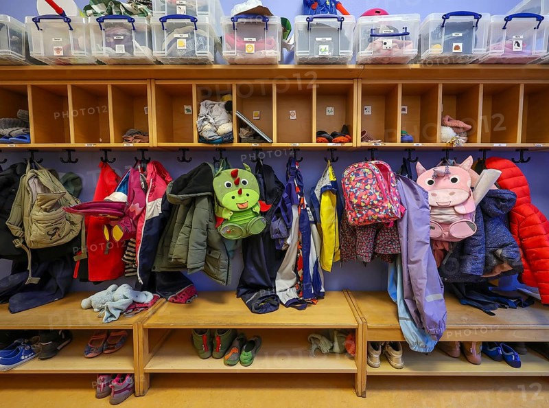 Germany - Symbolic image KITA. Children's coats, jackets and unicorn rucksacks hang on a coat rack in a kindergarten