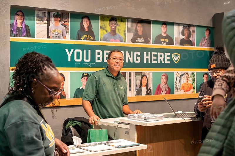 Detroit, Michigan - At Wayne State University on Noel Night, a recruiter talks to potential students. The annual Noel Night at the start of the holiday season in Detroit features open houses by arts and cultural institutions, churches, and small businesses.