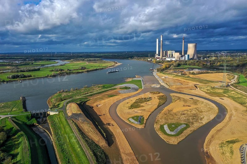 Dinslaken, Voerde, North Rhine-Westphalia, Germany, Inauguration of the new Emscher estuary into the Rhine. The decommissioned STEAG Voerde coal-fired power station is in the background. The mouth of the Emscher into the Rhine has been moved almost 500 metres north from Dinslaken to Voerde. Fish can now swim barrier-free up the new Emscher from the Rhine through a newly created floodplain area. Following the construction of a parallel sewer, the Emscher has been completely free of sewage since January 2022. The river was previously an open, above-ground combined sewer with rainwater and wastewater, Europe
