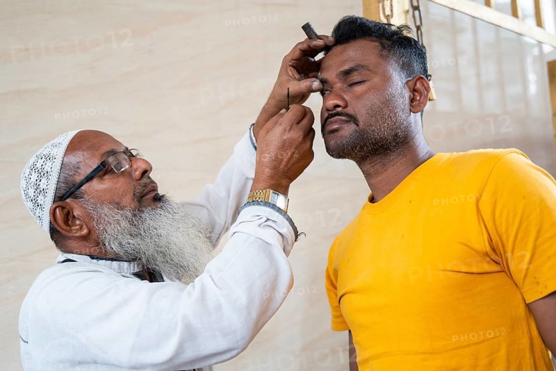 GUWAHATI, INDIA - MARCH 2: A Muslim person gets surma on eyes, as he arrives for Ramadan's first Iftar during Muslim holy month of Ramadan in Guwahati, India on March 2, 2025