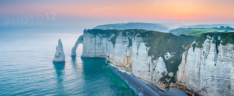The coast of Etretat (Étretat) at sunrise, cliffs with Porte d'Aval and Aiguille rock needle, Normandy, France, Europe