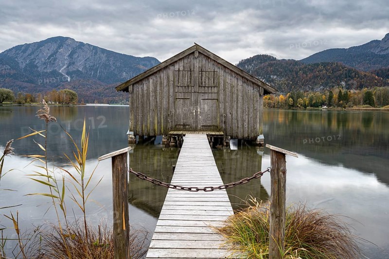Boathouse in the lake, Lake Kochel in autumn with reflection, Upper Bavaria, Bavaria, Germany, Europe