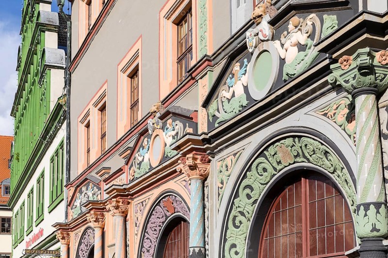 Ornate Renaissance portals on the Cranach House and the neighbouring town houses on Weimar's market square, with the town hall in the background, Thuringia, Germany, Europe