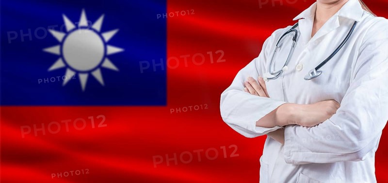 Doctor With Crossed Arms On Taiwanese Flag. Taiwan Health And Care Concept. Female Doctor On Taiwanese Flag