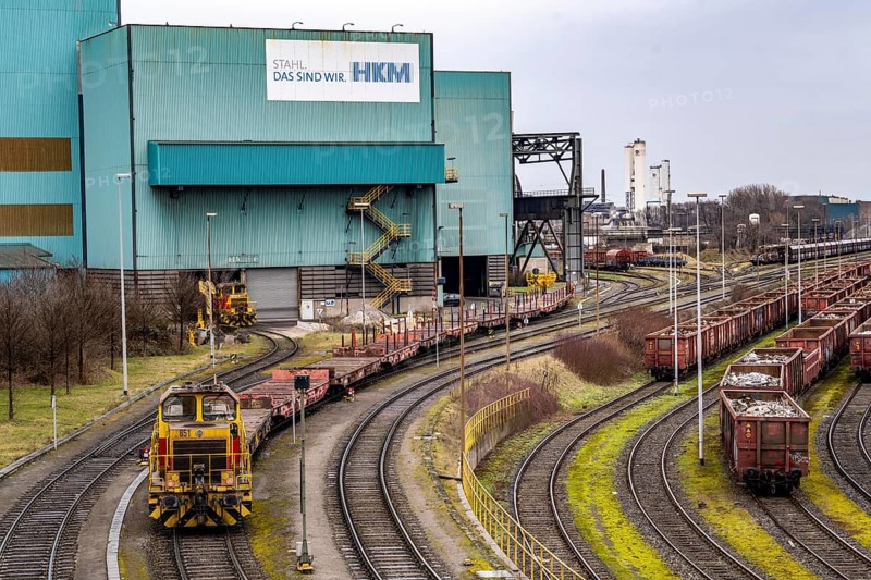 Hüttenwerke Krupp-Mannesmann, HKM in Duisburg, halls of the blast furnace steelworks, tracks of the marshalling yard, locomotive with goods wagons North Rhine-Westphalia, Germany, Europe