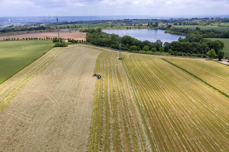 Aerial view of the Oberwartha reservoir, in the foreground a tractor with rake swathing hay, Dresden, Saxony, Germany, Europe