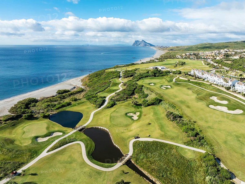 The La Hacienda Links Golf Resort at the Mediterranean Sea with the Rock of Gibraltar (British) in the distance. Aerial view. Drone shot. Cádiz province, Andalusia, Spain, Europe