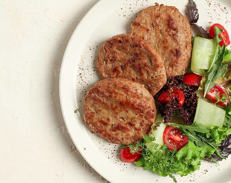 Fried cutlets, minced beef, with vegetable salad, top view, no people