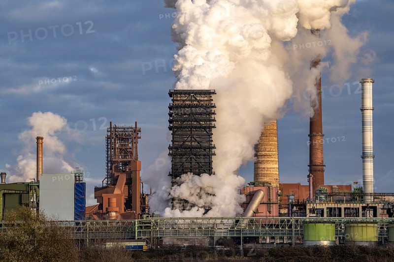 Industrial backdrop of the ThyssenKrupp Steel steelworks in Duisburg-Bruckhausen, on the Rhine, blast furnaces, Schwelgern coking plant, extinguishing cloud, Duisburg, North Rhine-Westphalia, Germany, Europe