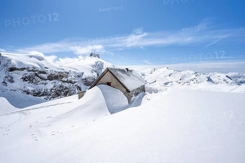 Snow-covered hut in winter, mountain landscape with snow, behind summit Rohrbachstein and Wildhorn, ascent to Wildstrubelhütte, Bernese Alps, Switzerland, Europe