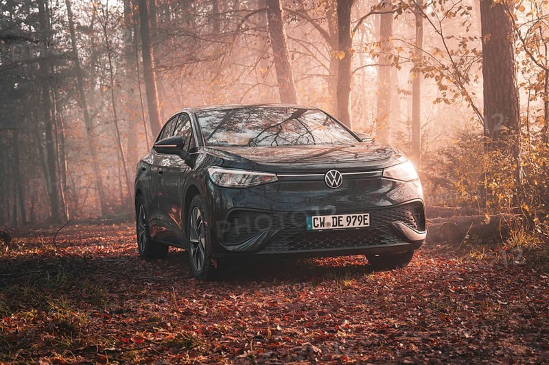 A Volkswagen is located in an autumnal misty forest and is illuminated by the evening light, electric car VW ID5, Deer Carsharing, Gechingen, Black Forest, Germany, Europe