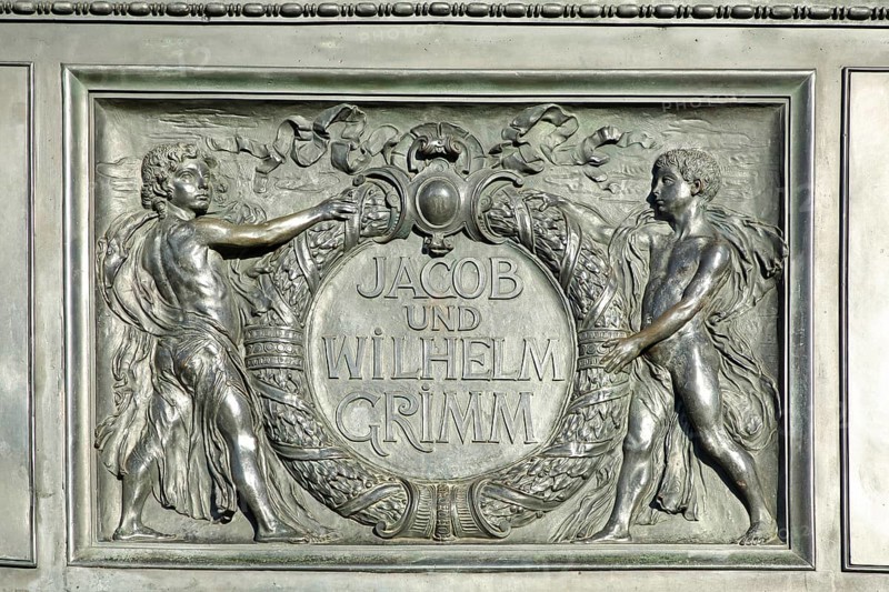 Relief on the Brothers Grimm National Monument, Jacob and Wilhelm with laurel wreath, inscription, monochrome, grey, Brothers, monument, German Fairy Tale Route, market square, Hanau, Hesse, Germany, Europe