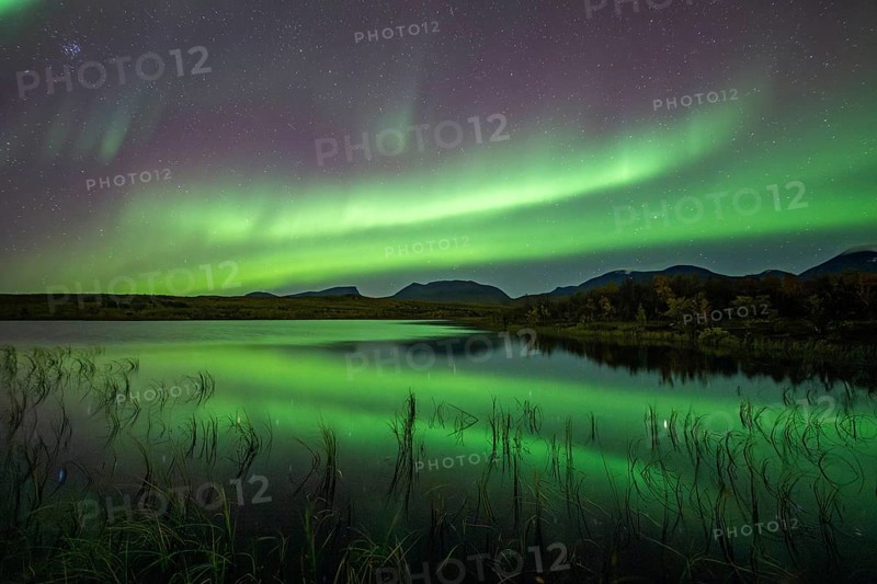 Northern lights reflected in lake, Lapporten, Abisko National Park, Lapland, Sweden, Europe