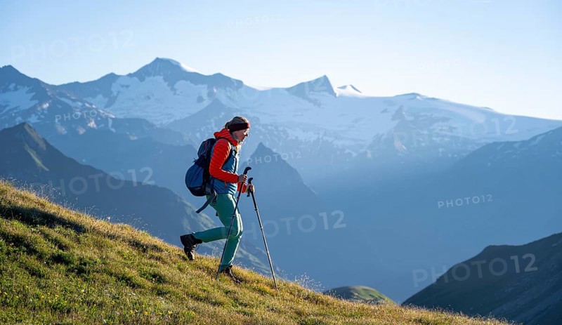 Hiker enjoying the mountain panorama in the morning, Venediger group, behind Dreiherrenkopf, Simonysitze and Großer Geiger, Hohen Tauern, Austria, Europe