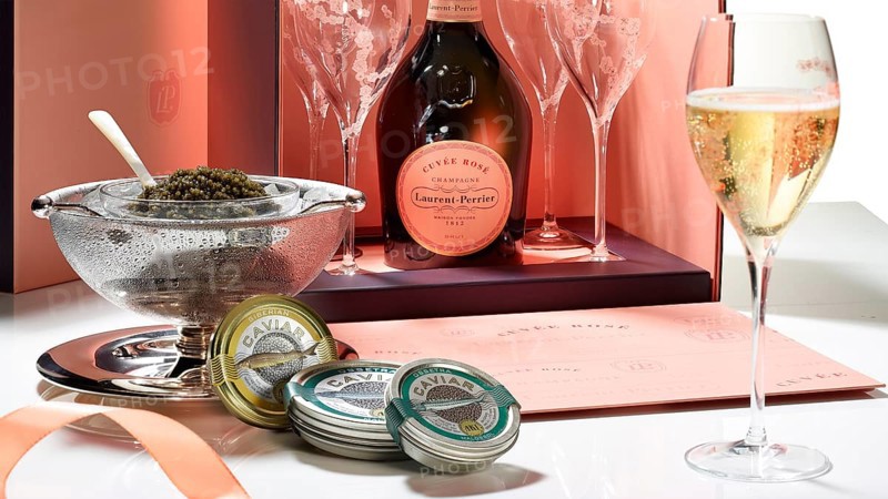 Champagne bottle with glasses, caviar, caviar tins, studio shot