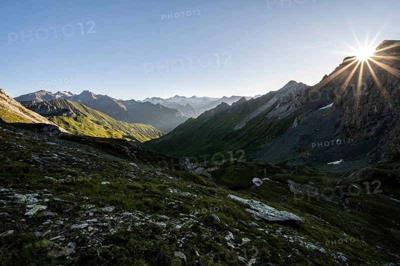 Mountain landscape at sunrise with sun star, view of mountain peaks of the Venediger group and into the Großbachtal valley from the summit of Bachlenkenkopf, Lasörling group, Hohe Tauern National Park, East Tyrol, Tyrol, Austria, Europe
