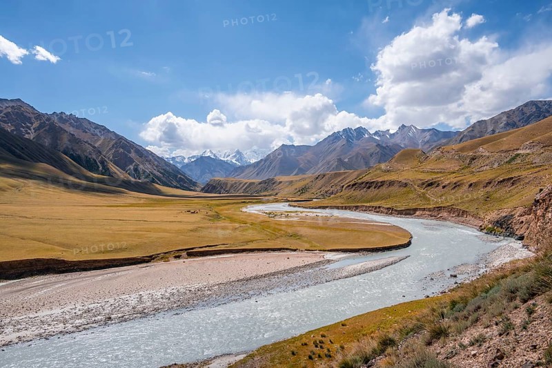 Mountain river in a valley, picturesque mountain landscape with white mountain peaks, Tian Shan Mountains, Issyk-Kul, Kyrgyzstan, Asia