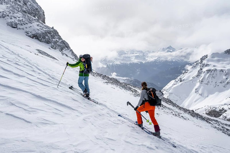 Ski tourers in a snowy mountain landscape, ascent to the Wildhorn, cloudy mood, high tour, Bernese Alps, Bernese Oberland, Switzerland, Europe