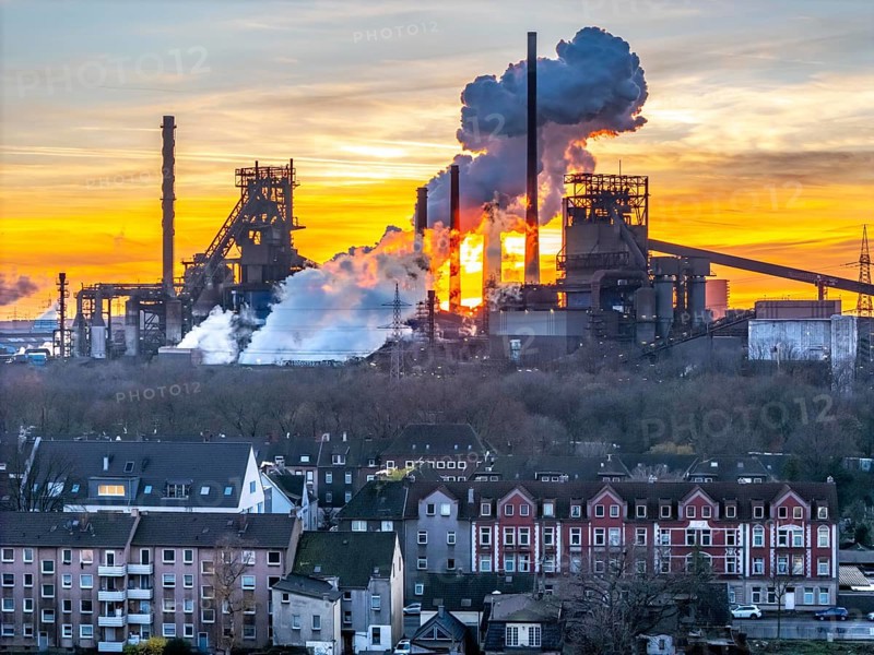 Blast furnaces Schwelgern 1 and 2, residential buildings in Duisburg-Marxloh, extinguishing cloud of the Schwelgern coking plant, ThyssenKrupp Steel, sunset, Duisburg, North Rhine-Westphalia, Germany, Europe