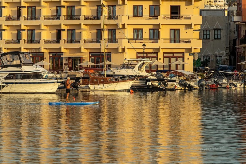 Stand-up paddlers in the harbour of Chania, Crete, Greece, Europe