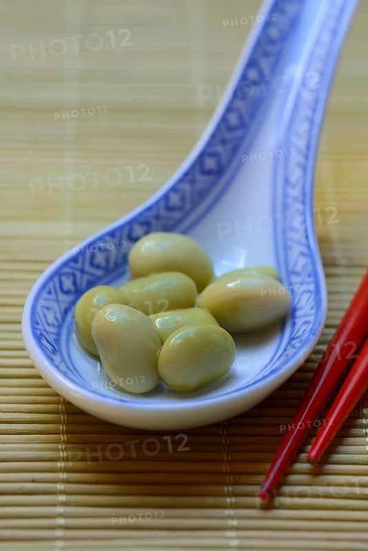 Edamame, unripe soya beans in an Asian ceramic spoon, Glycine max