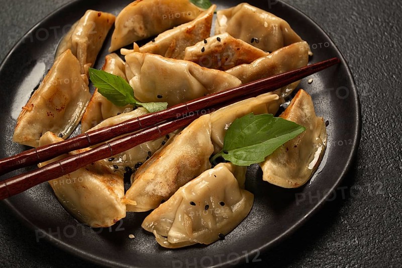 Japanese fried dumplings, gyoza, sesame seeds, top view, no people