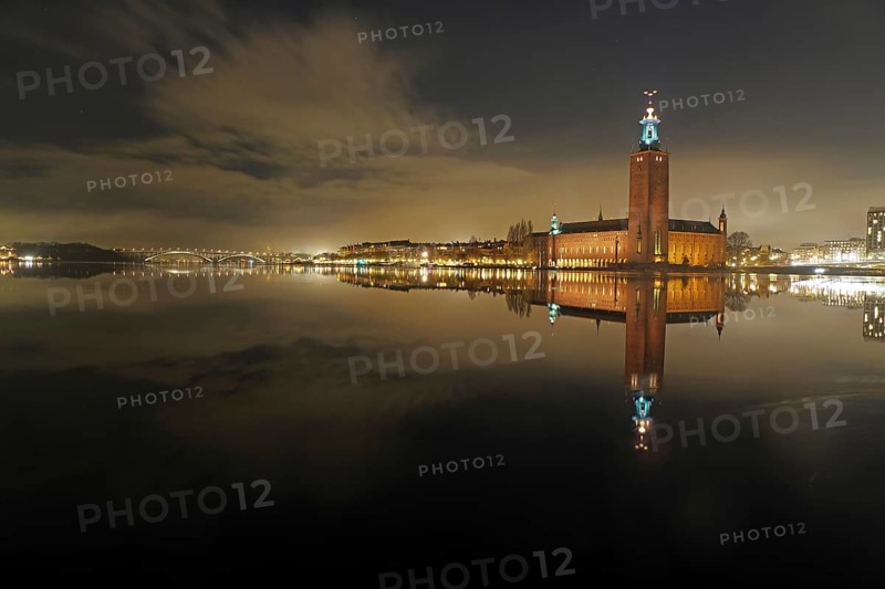 Night city view with illuminated tower and bridges in the background, winter, ice, capital, city hall, Stadshus, Nobel Prize, Stockholm, Sweden, Europe
